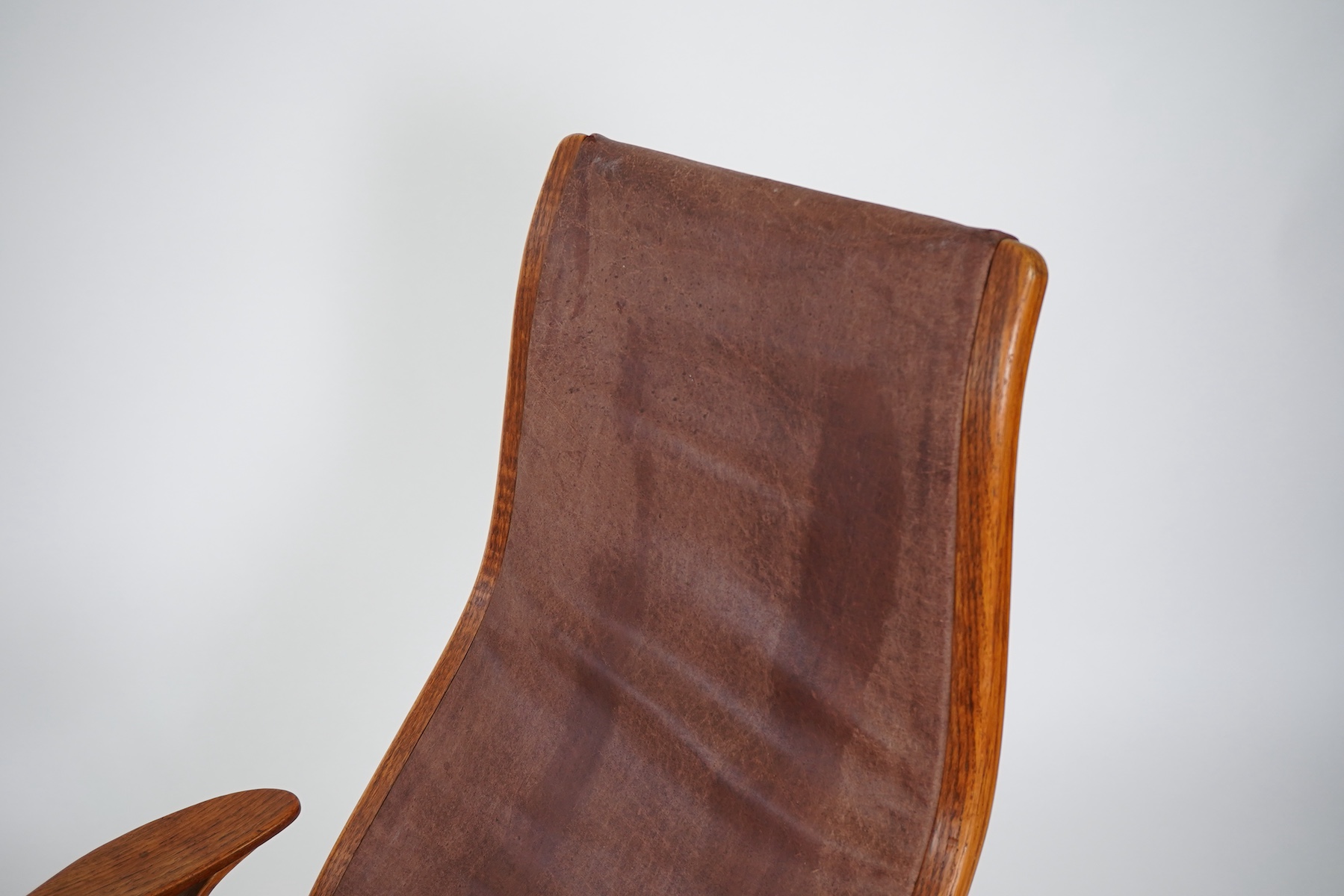 Yngve Ekström (Swedish, 1913-1998) for Swedese Möbler AB: A 'Lamino' oak lounge chair and ottoman